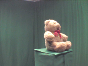 315 Degrees _ Picture 9 _ Brown Teddy Bear Wearing Red Bow.png